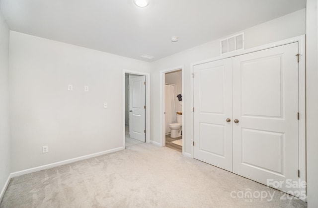 508 Morrows Turnout Way Unit 97, Pineville, NC 28134 - unfurnished bedroom with light carpet, a closet, and connected bathroom