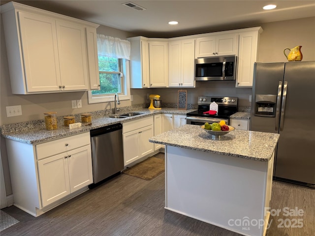 212 Old Centergrove Rd, Kannapolis, NC 28083 - kitchen featuring stainless steel appliances, dark wood finished floors, white cabinetry, recessed lighting, and light stone countertops