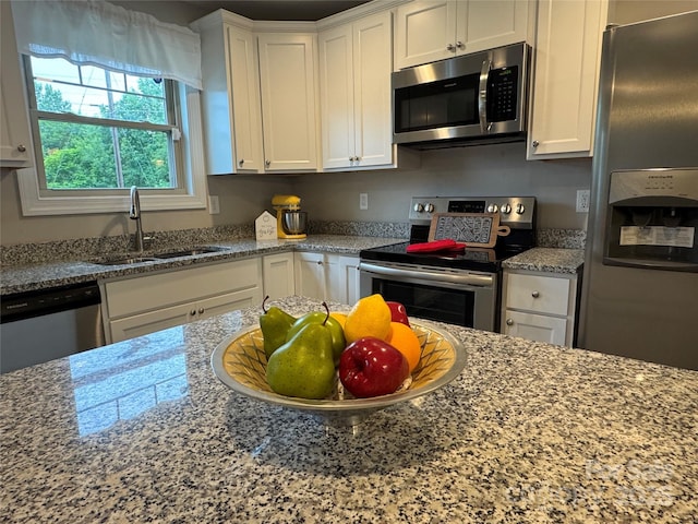 212 Old Centergrove Rd, Kannapolis, NC 28083 - kitchen with stainless steel appliances, white cabinets, and light stone counters