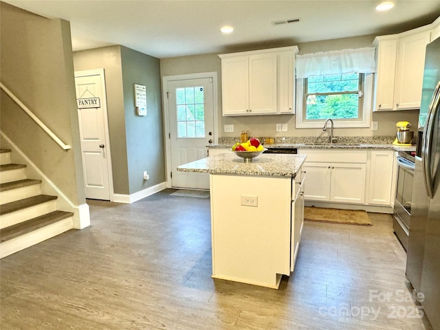 212 Old Centergrove Rd, Kannapolis, NC 28083 - kitchen featuring white cabinetry, wood finished floors, and recessed lighting