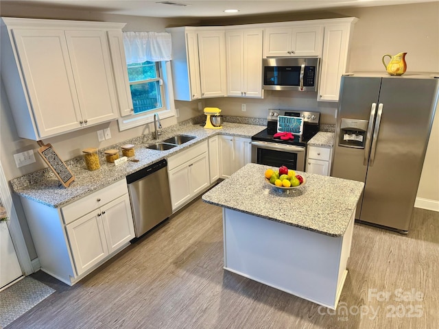 212 Old Centergrove Rd, Kannapolis, NC 28083 - kitchen featuring appliances with stainless steel finishes, light wood finished floors, white cabinets, light stone counters, and recessed lighting