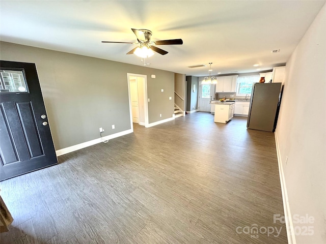 212 Old Centergrove Rd, Kannapolis, NC 28083 - unfurnished living room with stairs, dark wood finished floors, and ceiling fan
