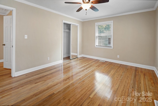 2830 Royston Rd Unit 2, Charlotte, NC 28208 - unfurnished bedroom with light wood-style floors, ornamental molding, a closet, and a ceiling fan