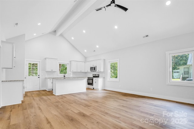 7 S Coulter Ave, Newton, NC 28658 - kitchen featuring appliances with stainless steel finishes, beam ceiling, a ceiling fan, a center island, and high vaulted ceiling