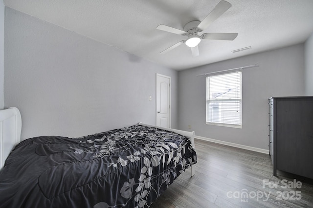 374 Morning Dew Dr, Concord, NC 28025 - bedroom featuring wood finished floors, ceiling fan, and a textured ceiling