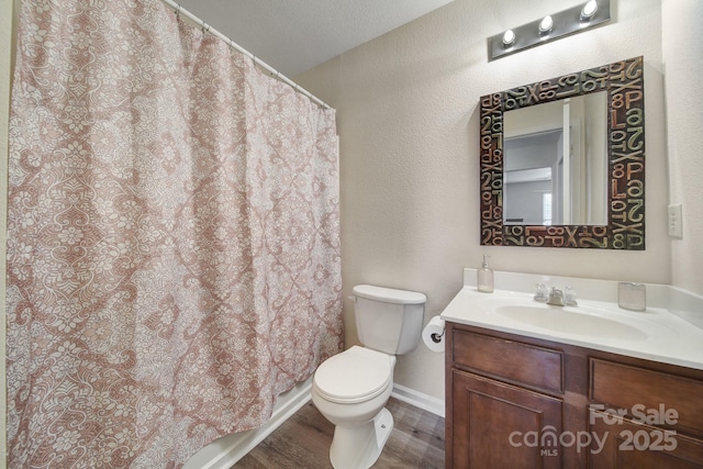 374 Morning Dew Dr, Concord, NC 28025 - bathroom with vanity, wood finished floors, curtained shower, and a textured wall