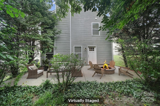 374 Morning Dew Dr, Concord, NC 28025 - rear view of house with an outdoor fire pit and a patio