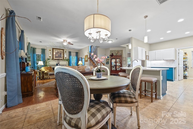 7029 Scuppernong Ct, Charlotte, NC 28215 - dining space with a ceiling fan, recessed lighting, a chandelier, and light tile patterned floors