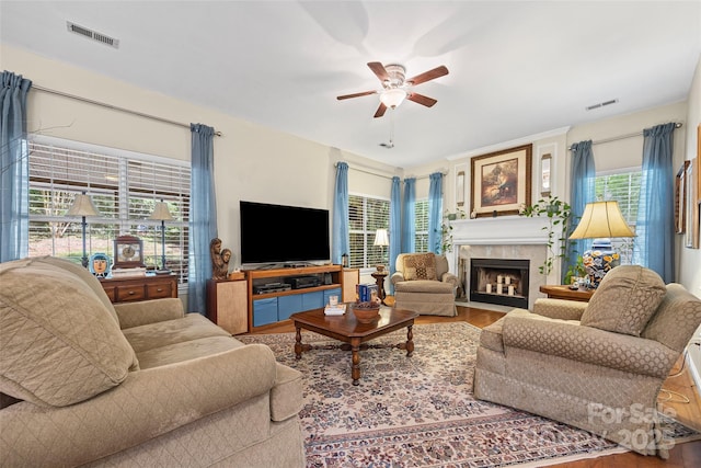 7029 Scuppernong Ct, Charlotte, NC 28215 - living room featuring ceiling fan, wood finished floors, and a fireplace with flush hearth