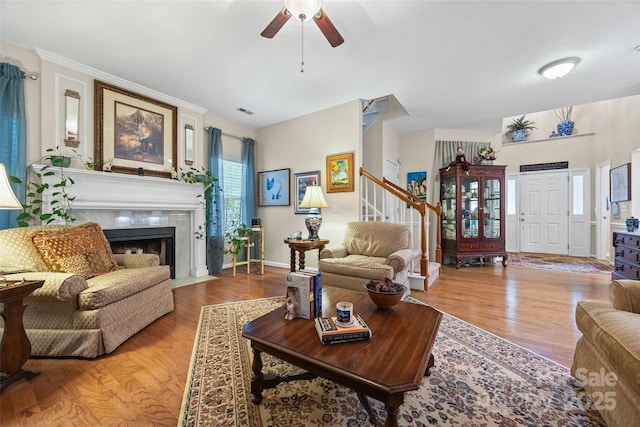 7029 Scuppernong Ct, Charlotte, NC 28215 - living room with ceiling fan, a fireplace with flush hearth, stairs, and light wood finished floors