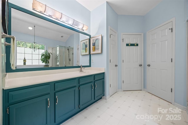 7029 Scuppernong Ct, Charlotte, NC 28215 - bathroom featuring a stall shower, vanity, and a chandelier