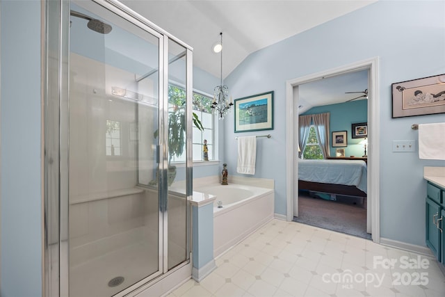 7029 Scuppernong Ct, Charlotte, NC 28215 - full bath with vanity, a shower stall, a garden tub, vaulted ceiling, and connected bathroom