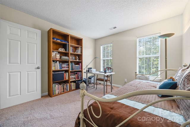 7029 Scuppernong Ct, Charlotte, NC 28215 - carpeted bedroom featuring a textured ceiling and a desk