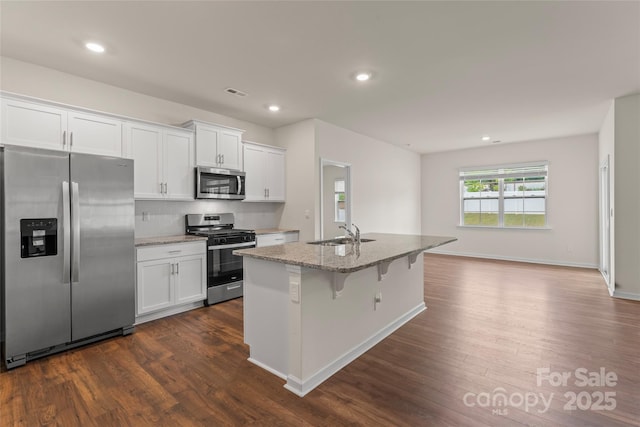 3505 Sycamore Crossing Ct, Mount Holly, NC 28120 - kitchen with appliances with stainless steel finishes, light stone counters, dark wood finished floors, white cabinets, and recessed lighting