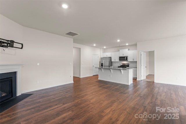 3505 Sycamore Crossing Ct, Mount Holly, NC 28120 - unfurnished living room featuring dark wood finished floors, recessed lighting, and a fireplace with flush hearth