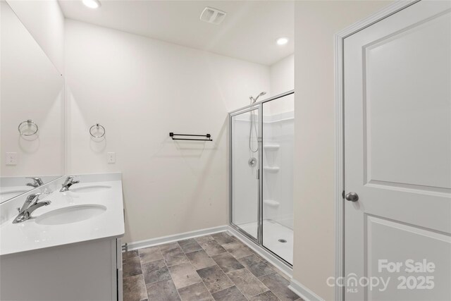 3505 Sycamore Crossing Ct, Mount Holly, NC 28120 - full bathroom featuring double vanity, a stall shower, stone finish floors, and recessed lighting