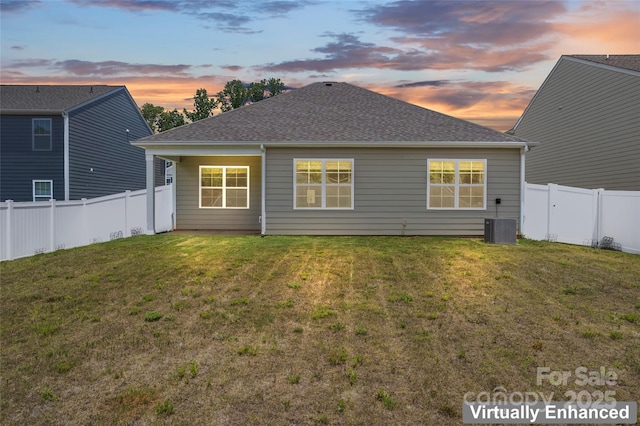 3505 Sycamore Crossing Ct, Mount Holly, NC 28120 - back of house at dusk with a fenced backyard and roof with shingles