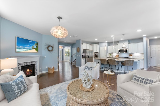 17514 Julees Walk Ln, Davidson, NC 28036 - living area with dark wood-style flooring, a fireplace, recessed lighting, and stairway