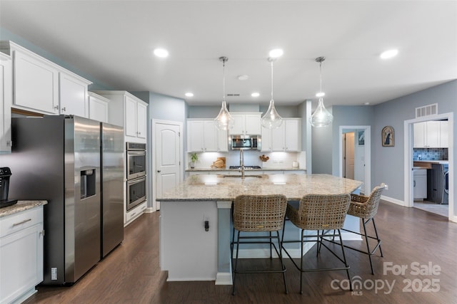 17514 Julees Walk Ln, Davidson, NC 28036 - kitchen with stainless steel appliances, tasteful backsplash, white cabinetry, dark wood-style floors, and recessed lighting