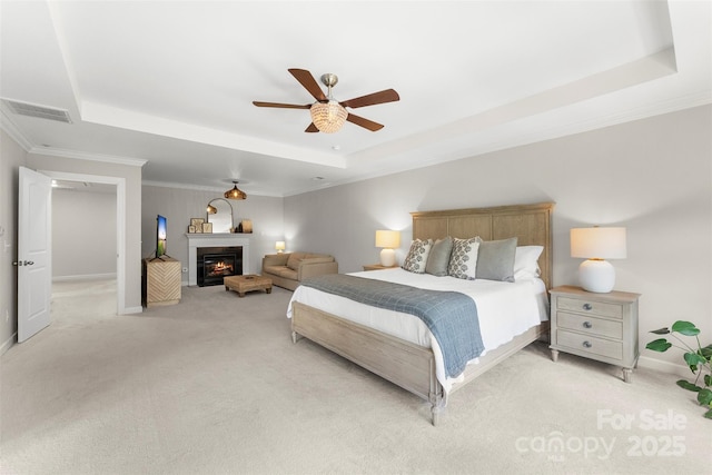 17514 Julees Walk Ln, Davidson, NC 28036 - bedroom with a raised ceiling, light carpet, crown molding, a ceiling fan, and a glass covered fireplace