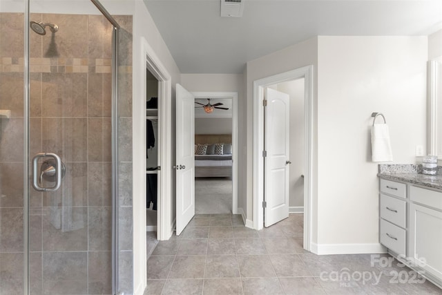 17514 Julees Walk Ln, Davidson, NC 28036 - bathroom with a ceiling fan, vanity, a walk in closet, a stall shower, and tile patterned flooring