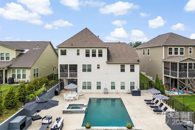 17514 Julees Walk Ln, Davidson, NC 28036 - back of house with a fenced backyard, a sunroom, a patio, and a pool with connected hot tub
