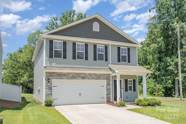 2014 Karen Woods Ln, Charlotte, NC 28216 - view of front of home featuring a front lawn, an attached garage, concrete driveway, and stone siding