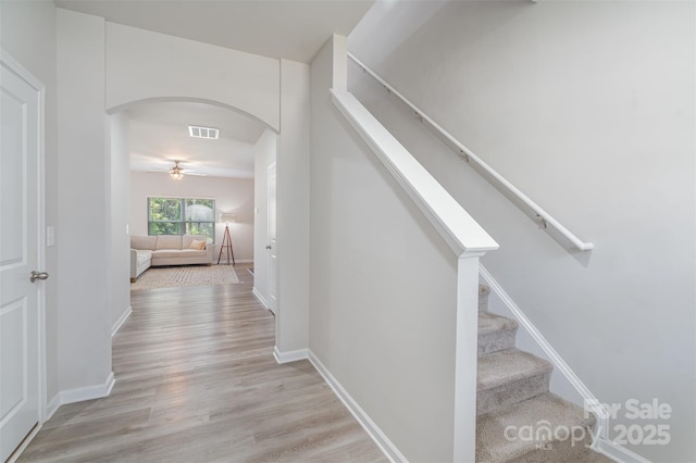 2014 Karen Woods Ln, Charlotte, NC 28216 - stairway featuring arched walkways, wood finished floors, and a ceiling fan