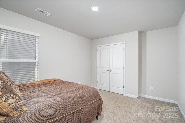 2014 Karen Woods Ln, Charlotte, NC 28216 - bedroom featuring light carpet, a closet, and recessed lighting