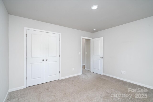 2014 Karen Woods Ln, Charlotte, NC 28216 - unfurnished bedroom featuring carpet flooring, a closet, and recessed lighting