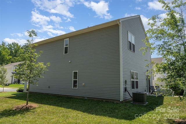2014 Karen Woods Ln, Charlotte, NC 28216 - view of side of property featuring a lawn and a central AC unit