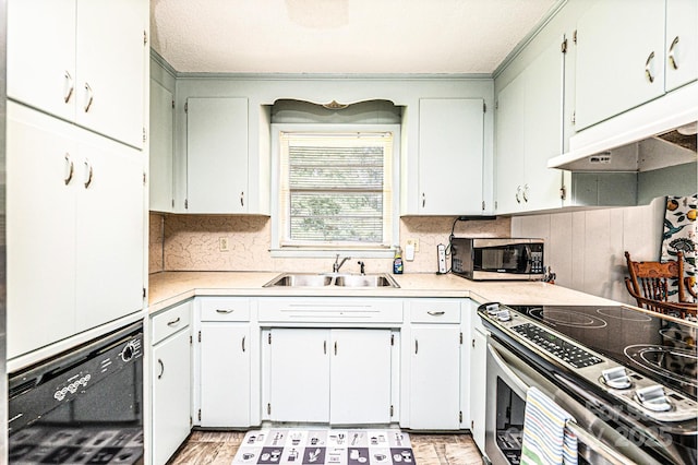 1008 2nd St SE, Conover, NC 28613 - kitchen with appliances with stainless steel finishes, backsplash, light countertops, and under cabinet range hood
