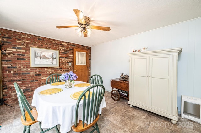 1008 2nd St SE, Conover, NC 28613 - dining space with ceiling fan, brick wall, and heating unit