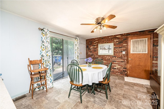 1008 2nd St SE, Conover, NC 28613 - dining space with brick wall, a ceiling fan, and ornamental molding