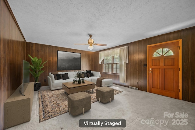 18 Progress Ln, Candler, NC 28715 - living room with a ceiling fan, wooden walls, carpet, and a textured ceiling