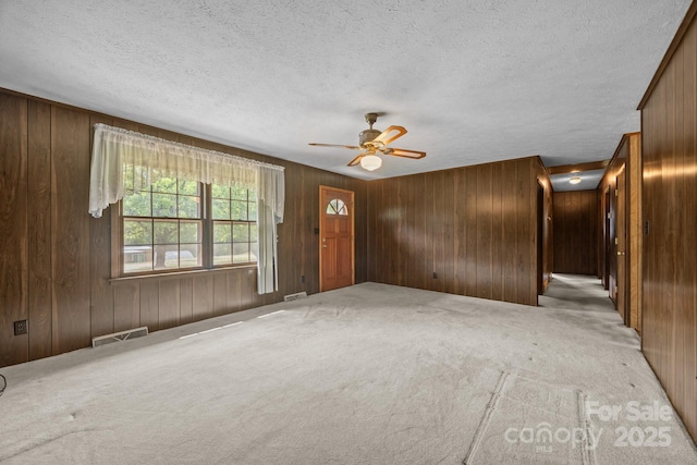 18 Progress Ln, Candler, NC 28715 - carpeted foyer entrance with wooden walls, a ceiling fan, and a textured ceiling