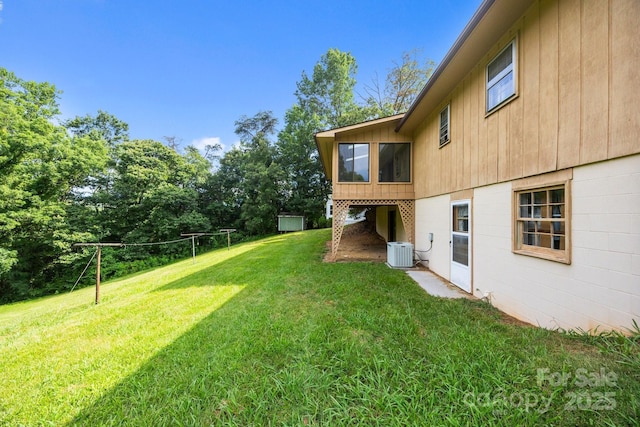 18 Progress Ln, Candler, NC 28715 - view of green lawn with a sunroom and view of wooded area