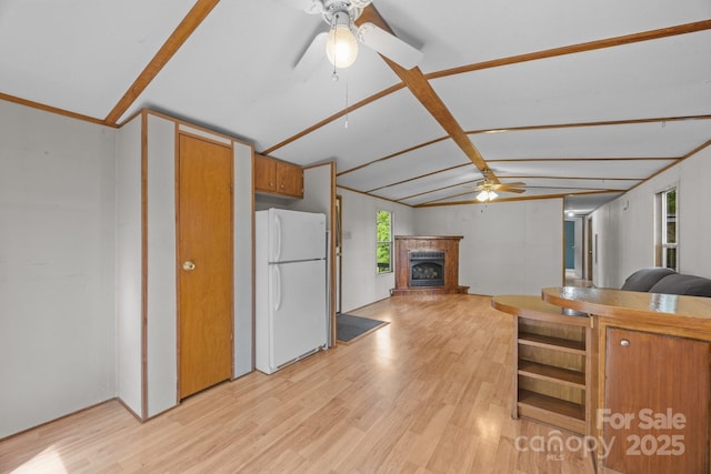 18 Progress Ln, Candler, NC 28715 - kitchen featuring freestanding refrigerator, ceiling fan, light wood-type flooring, and a fireplace with raised hearth