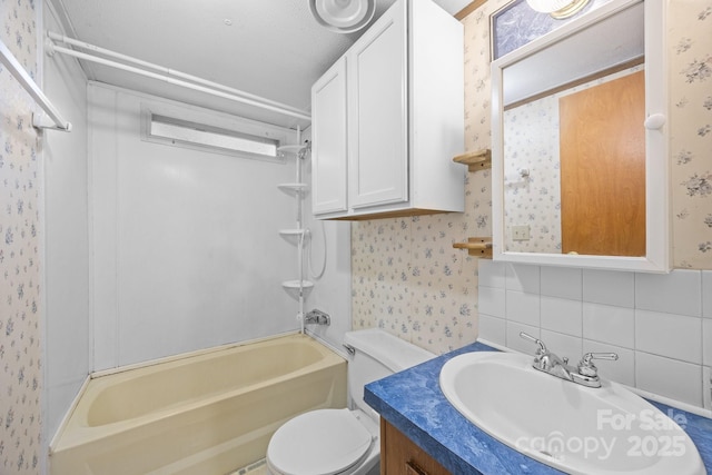 18 Progress Ln, Candler, NC 28715 - bathroom with wallpapered walls, shower / tub combination, vanity, and decorative backsplash
