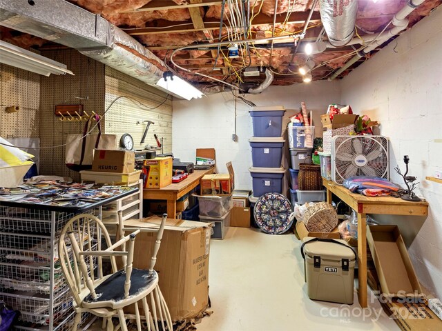 64 Wells Ln, Tryon, NC 28782 - unfinished basement with a workshop area and concrete block wall