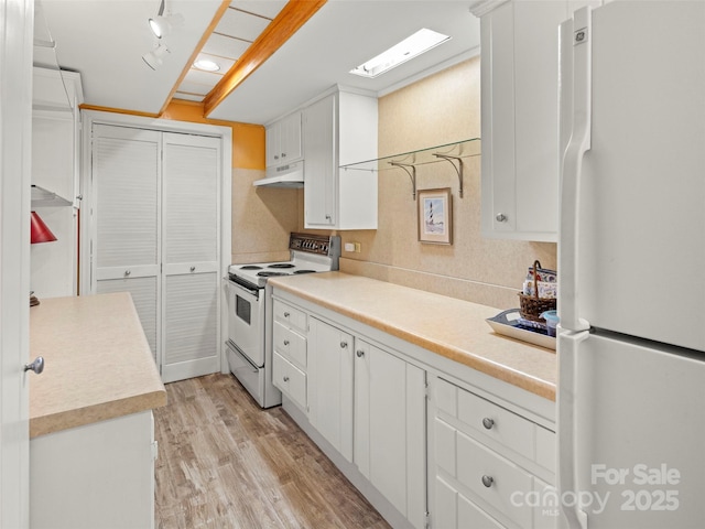 64 Wells Ln, Tryon, NC 28782 - kitchen featuring white appliances, white cabinets, light countertops, and under cabinet range hood