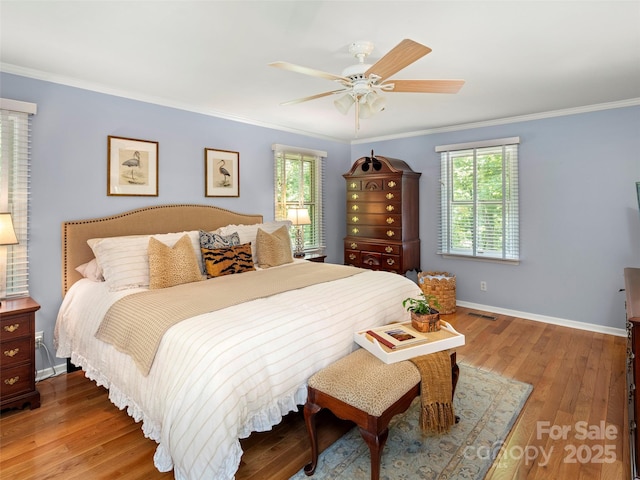 64 Wells Ln, Tryon, NC 28782 - bedroom featuring crown molding, multiple windows, wood finished floors, and a ceiling fan