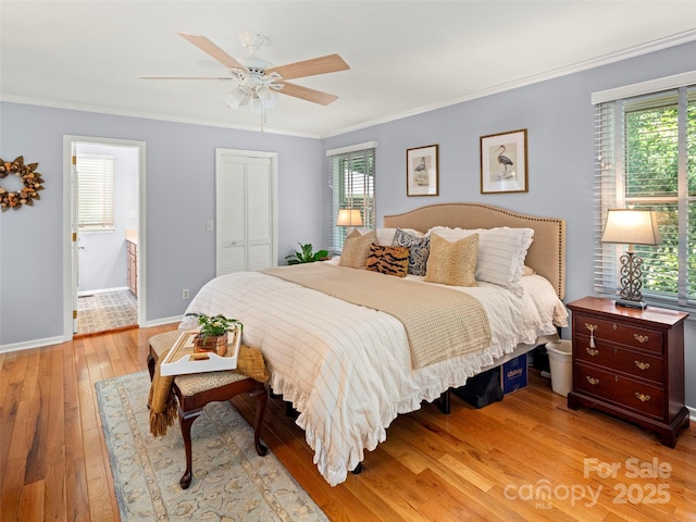 64 Wells Ln, Tryon, NC 28782 - bedroom featuring light wood finished floors, multiple windows, crown molding, a closet, and a ceiling fan