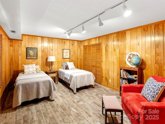 64 Wells Ln, Tryon, NC 28782 - bedroom featuring track lighting, wood walls, and wood finished floors