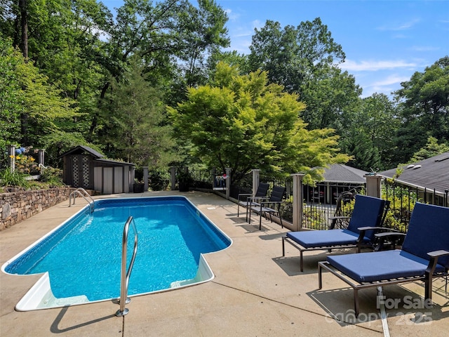 64 Wells Ln, Tryon, NC 28782 - view of swimming pool with a patio, a storage unit, and view of wooded area
