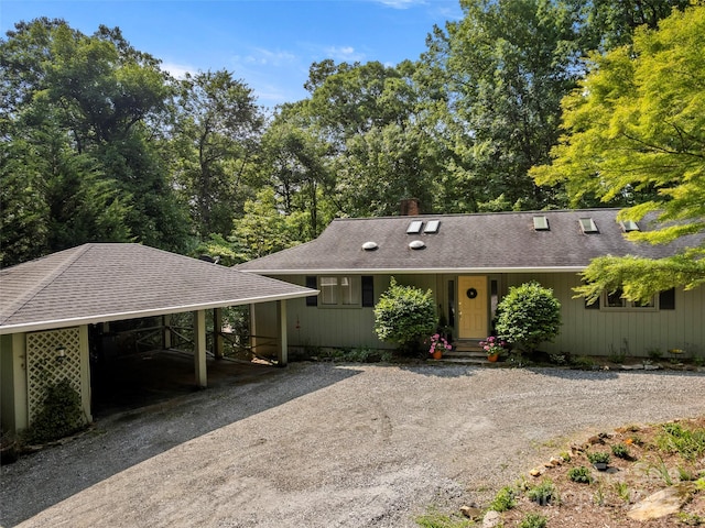 64 Wells Ln, Tryon, NC 28782 - ranch-style house featuring dirt driveway, roof with shingles, and a carport