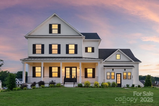 1106 Pomar Cir, Waxhaw, NC 28173 - back of property at dusk with french doors, covered porch, a standing seam roof, and a yard