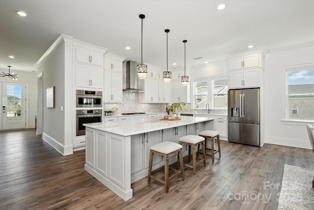 1106 Pomar Cir, Waxhaw, NC 28173 - kitchen featuring stainless steel appliances, wall chimney range hood, a center island, backsplash, and white cabinetry