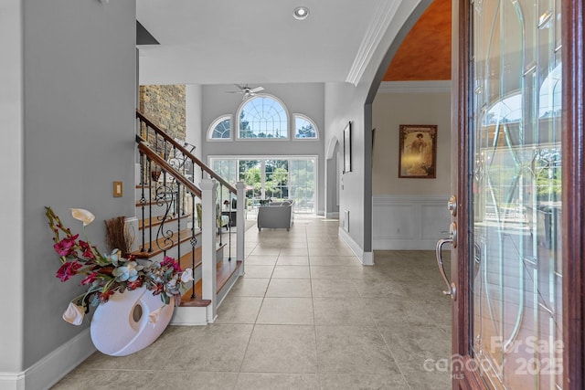 123 Yellow Jacket Cir, Mooresville, NC 28117 - foyer with ceiling fan, stairs, arched walkways, crown molding, and light tile patterned floors