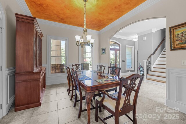 123 Yellow Jacket Cir, Mooresville, NC 28117 - dining area featuring arched walkways, ornamental molding, a decorative wall, a chandelier, and healthy amount of natural light